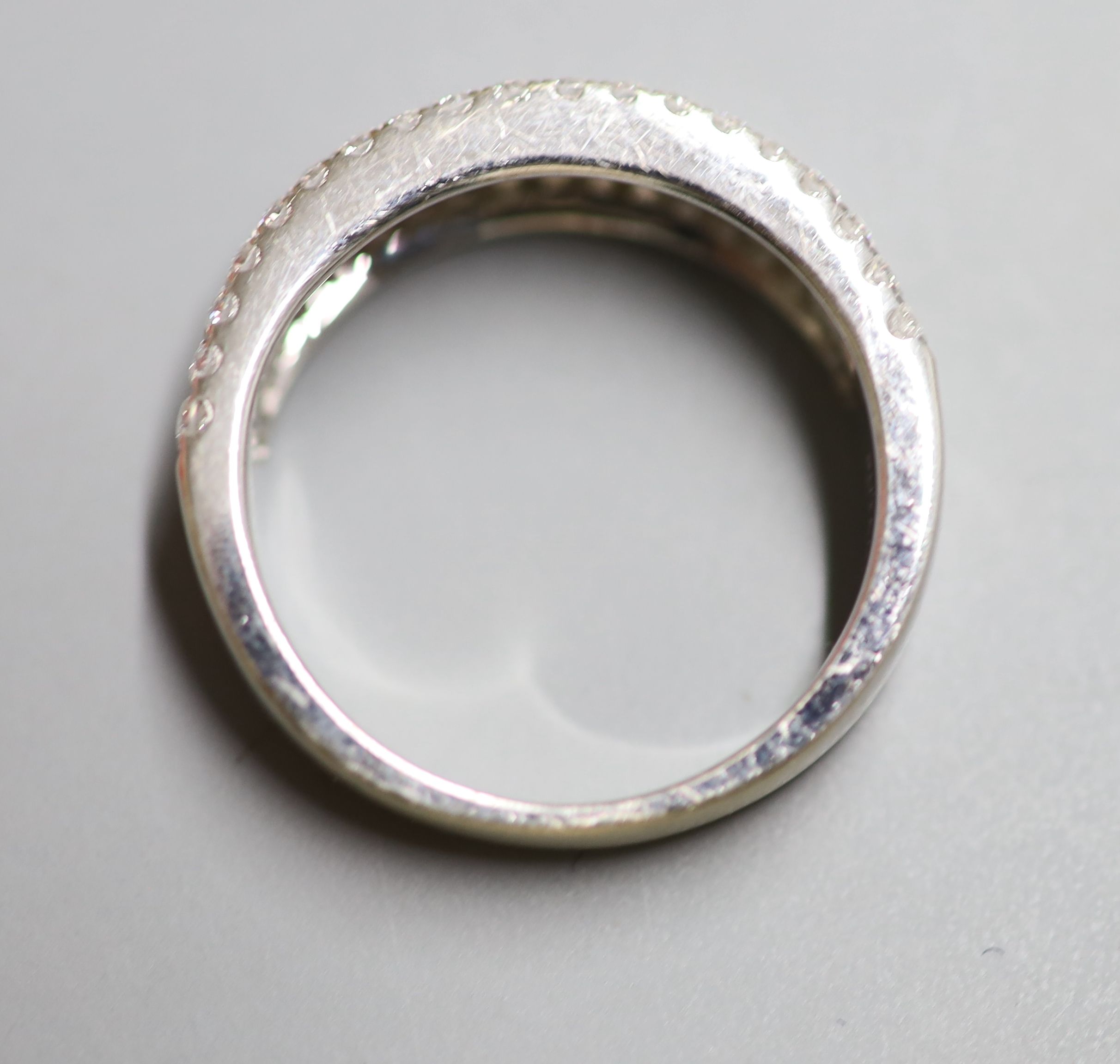 A modern 18k, baguette and round brilliant cut diamond set three row half eternity ring by Butani, size M, gross 5.2 grams.